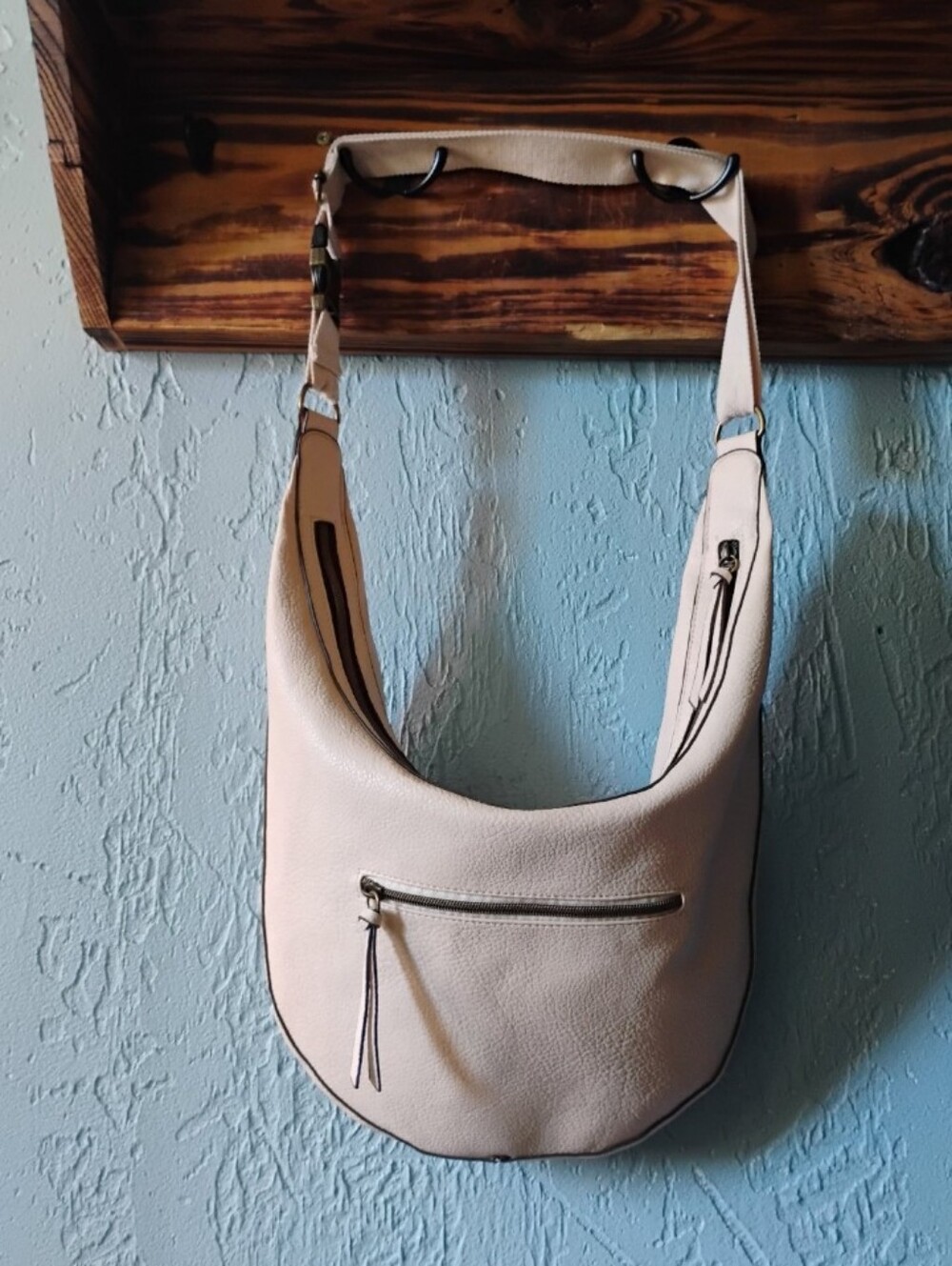 Hobo style shoulder bag with a modern geometric herringbone/chevron pattern.